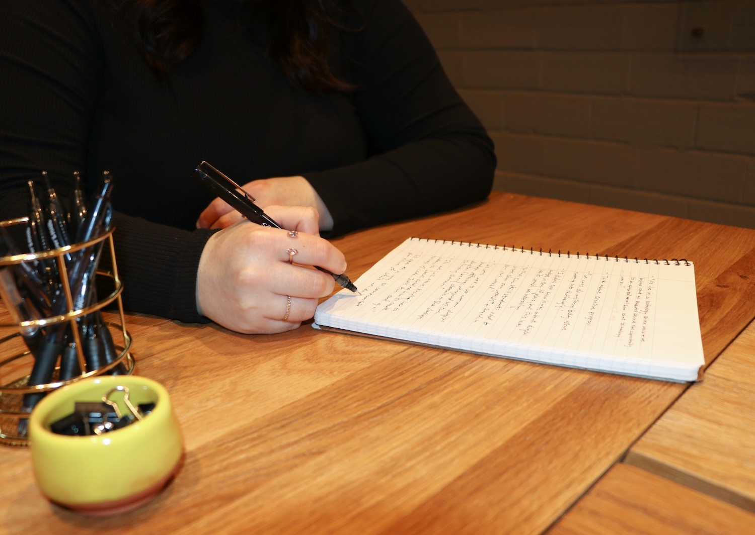 Person writing in a notebook.