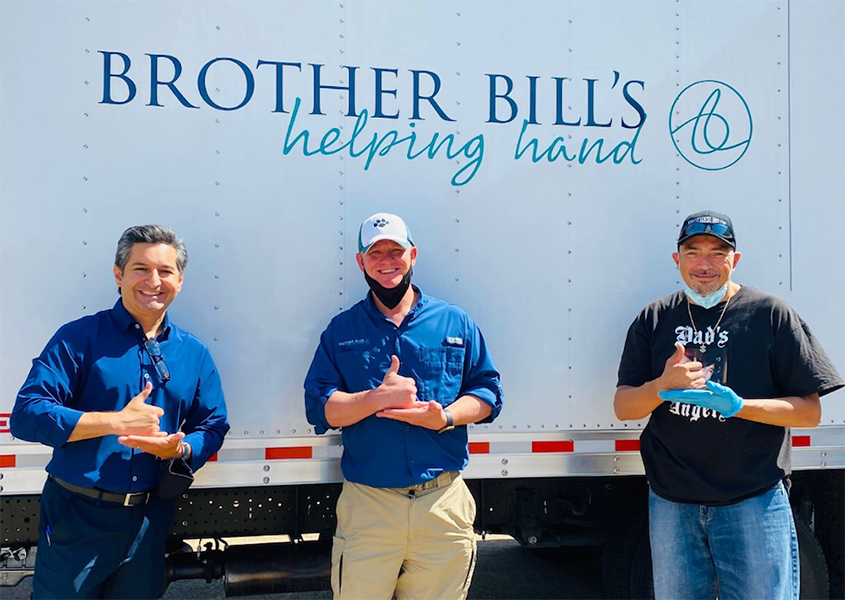 Photo of Manny Valencia with people from Brother Bill's Helping Hand